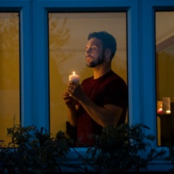 Man holding a candle in house