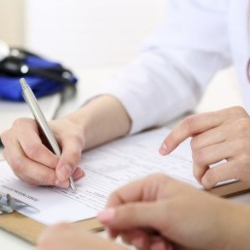 GP and patient completing a form