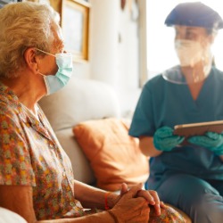 A female doctor visits a senior woman at the nursing home. iStock photo