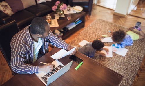 man working at home looking after children