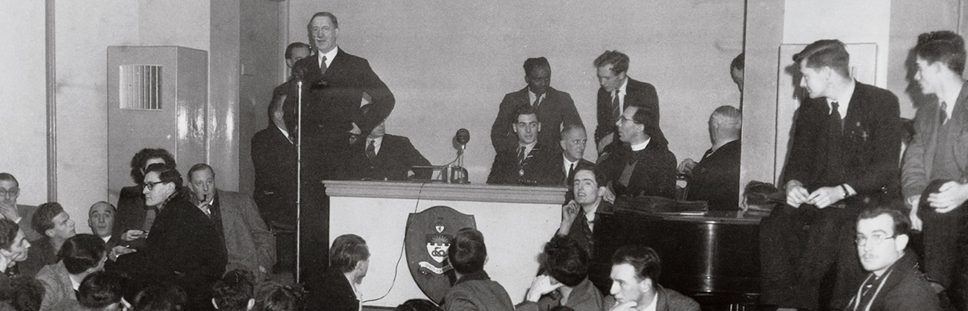 historical photo of students listening to speech given at the university
