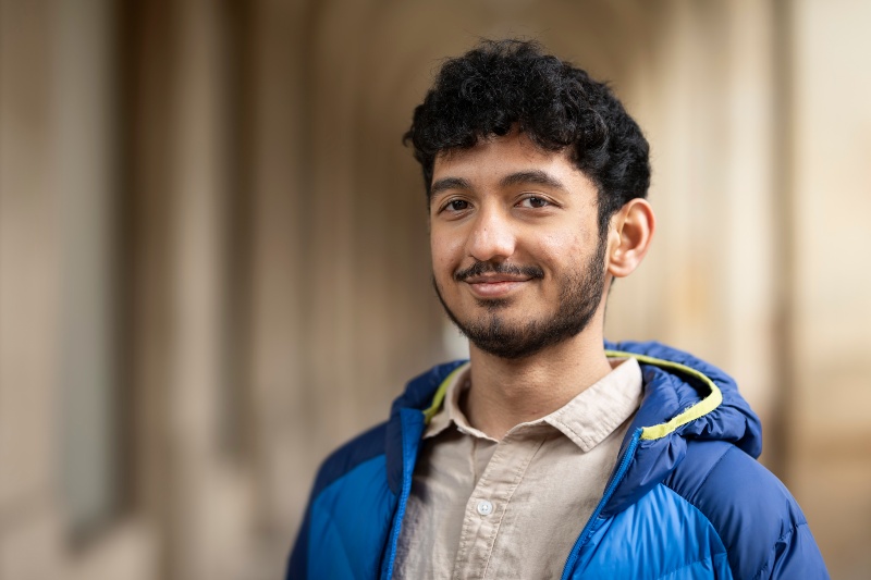 A student smiles at the camera.